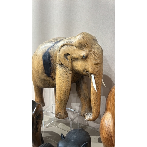 158 - Wooden figures of a cat and an elephant, showcasing detailed natural wood grain.