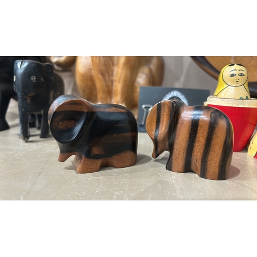 158 - Wooden figures of a cat and an elephant, showcasing detailed natural wood grain.