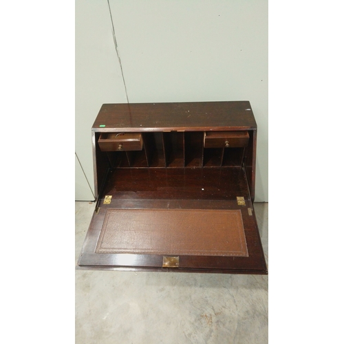 146 - Antique mahogany fold-top desk with brass hardware, claw-foot legs, and internal compartments.