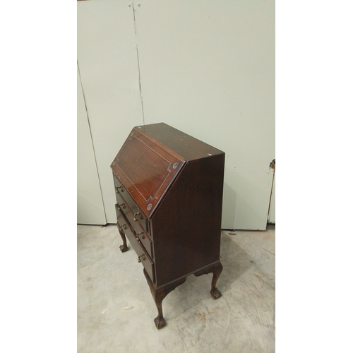 146 - Antique mahogany fold-top desk with brass hardware, claw-foot legs, and internal compartments.