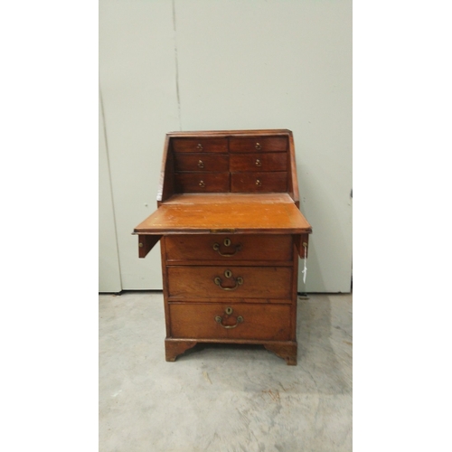 148 - Antique oak bureau from the Edwardian period, featuring drop front, multiple drawers with brass hand... 