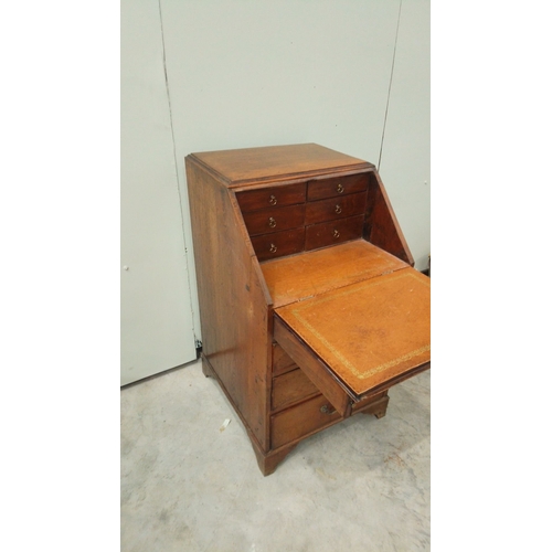 148 - Antique oak bureau from the Edwardian period, featuring drop front, multiple drawers with brass hand... 