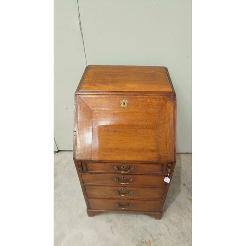 148 - Antique oak bureau from the Edwardian period, featuring drop front, multiple drawers with brass hand... 