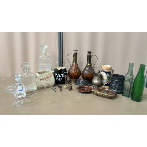 162 - Mixed lot featuring vintage glass bottles, ceramic steins, pewter cup, crystal decanters, and cerami... 