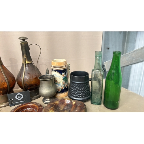 162 - Mixed lot featuring vintage glass bottles, ceramic steins, pewter cup, crystal decanters, and cerami... 