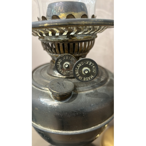 163 - Collection of six vintage oil lamps, featuring ornate glass and brass designs—an eclectic mix showca... 