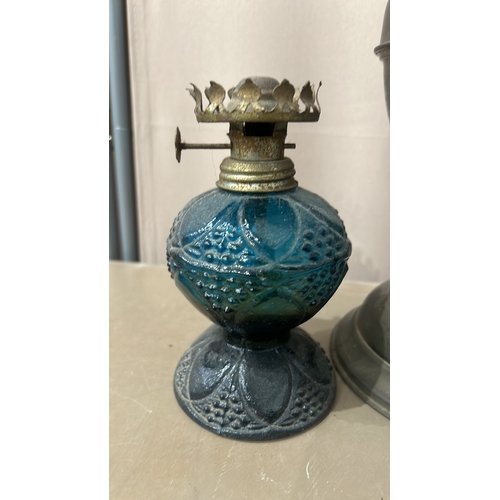 163 - Collection of six vintage oil lamps, featuring ornate glass and brass designs—an eclectic mix showca... 