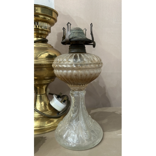 163 - Collection of six vintage oil lamps, featuring ornate glass and brass designs—an eclectic mix showca... 