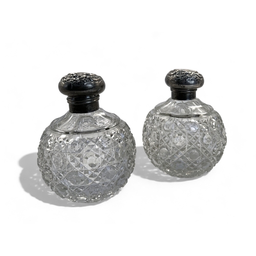 560 - A pair of Edwardian silver mounted crystal cut perfume bottles.Height - 11.5cm