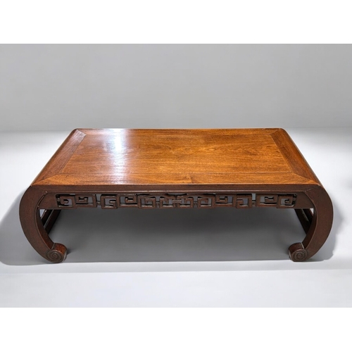 50 - A Chinese hardwood low Opium / Kang table.1st half 20th century.Rectangular form with scrolling patt... 