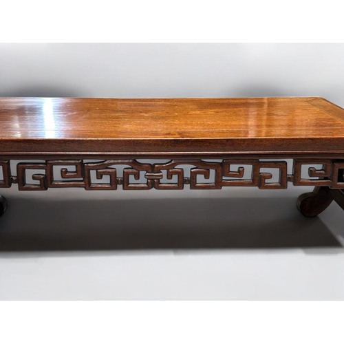 50 - A Chinese hardwood low Opium / Kang table.1st half 20th century.Rectangular form with scrolling patt... 