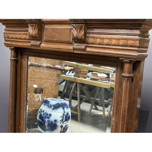 279 - A large carved Oak 'Green man' bevelled mirror.Supported by twin columns.