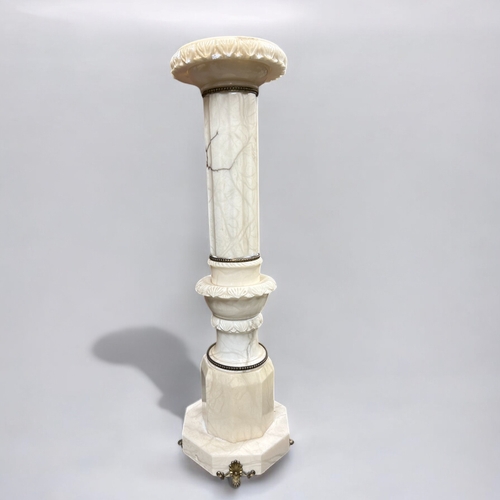 281 - An Italian carved Alabaster column pedestal plant stand.  With gilt metal mountings.This stand is 97... 