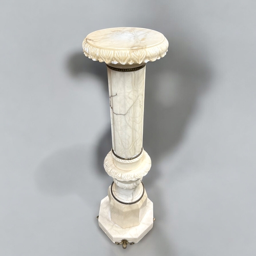 281 - An Italian carved Alabaster column pedestal plant stand.  With gilt metal mountings.This stand is 97... 