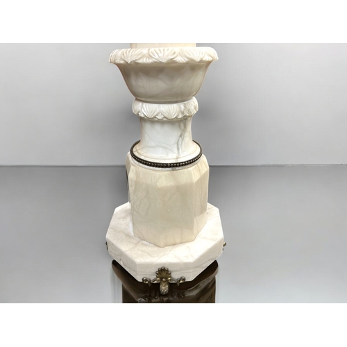 281 - An Italian carved Alabaster column pedestal plant stand.  With gilt metal mountings.This stand is 97... 