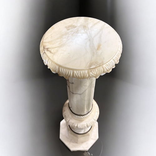 281 - An Italian carved Alabaster column pedestal plant stand.  With gilt metal mountings.This stand is 97... 