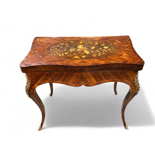 283 - A 19th century French Ormolu mounted Kingswood games table. Marquetry inlaid with foliate design and... 