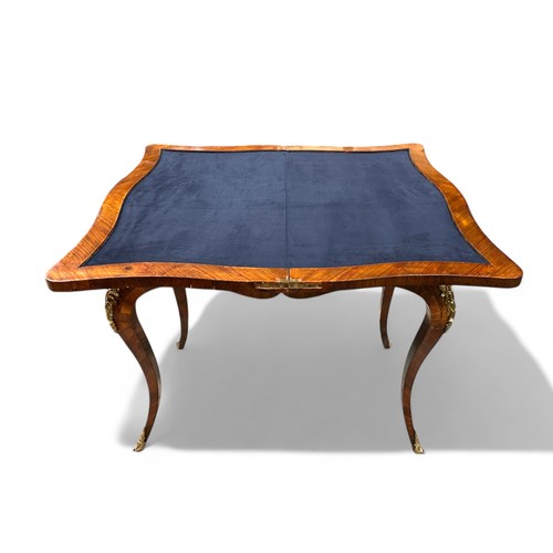 283 - A 19th century French Ormolu mounted Kingswood games table. Marquetry inlaid with foliate design and... 