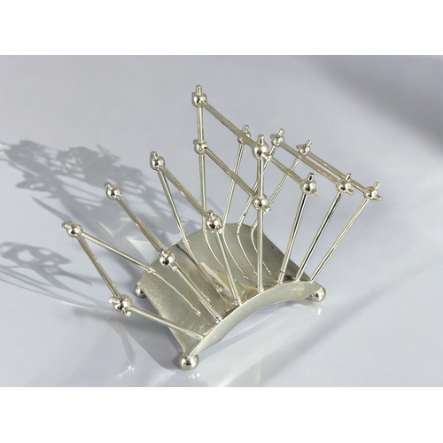 572 - A reproduction Christopher Dresser silver plate toast rack.17.5 x 22cm