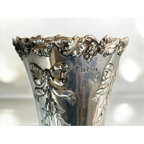 562 - A large silver spill vase.Bow & foliate design.