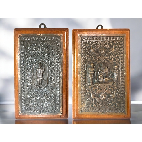 599 - A fine pair of Indian Bas relief decorated copper plaques.Raj period,19th century.Mounted on wood. F... 