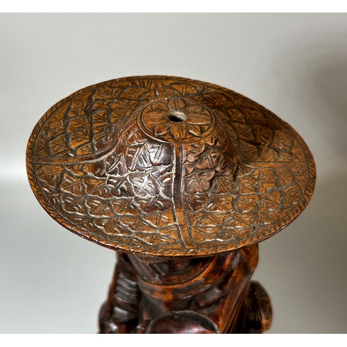 90 - A collection of Oriental wood carvings. Tallest - 28cm