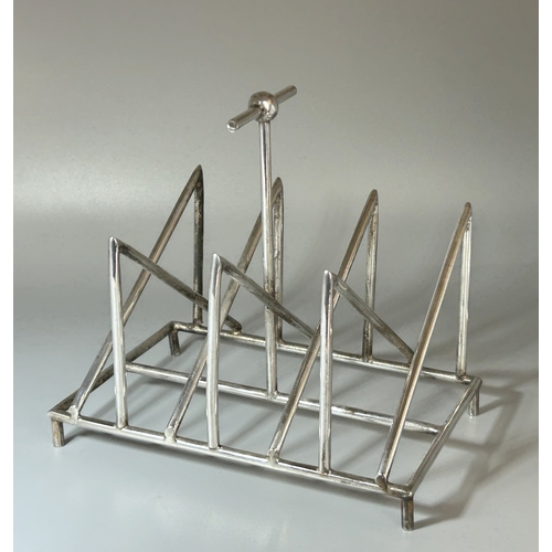 573 - A Christopher Dresser design silver plate toast rack.Tall T-Bar handle.Unmarked.16 x 15 x 10.5cm... 