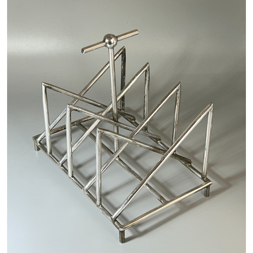 573 - A Christopher Dresser design silver plate toast rack.Tall T-Bar handle.Unmarked.16 x 15 x 10.5cm... 