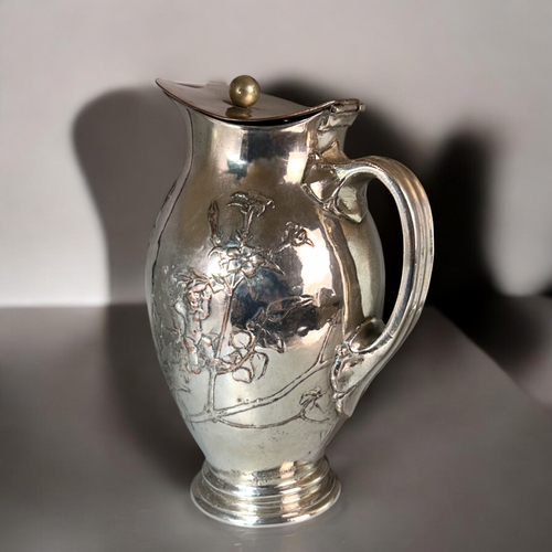 537 - An Art Nouveau silver on copper Ewer.Signed E. Arnold, 1918.Relief decorated with Cherubs and fairie... 