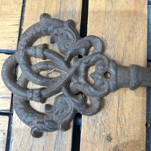 45 - Ornate cast iron wall hook in key shape, featuring five hooks. And a cast iron door stop in the form... 