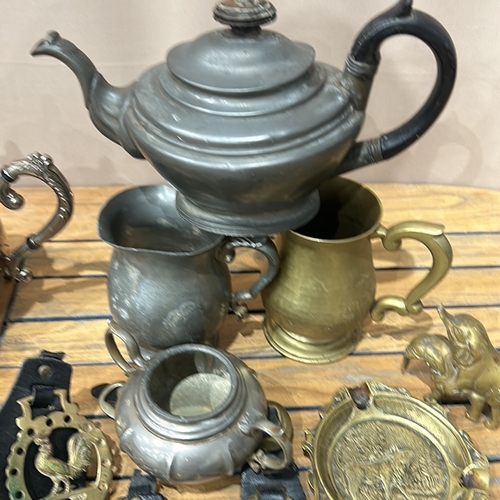 55 - Collection of vintage brass horse brasses on leather, alongside assorted metalware including teapots... 