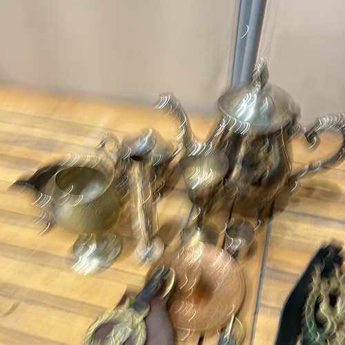 55 - Collection of vintage brass horse brasses on leather, alongside assorted metalware including teapots... 