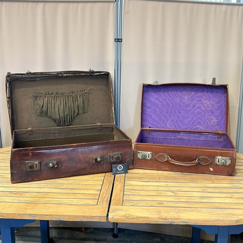 58 - Vintage leather suitcases with sturdy handles, brass clasps, and original interior linings. Features... 