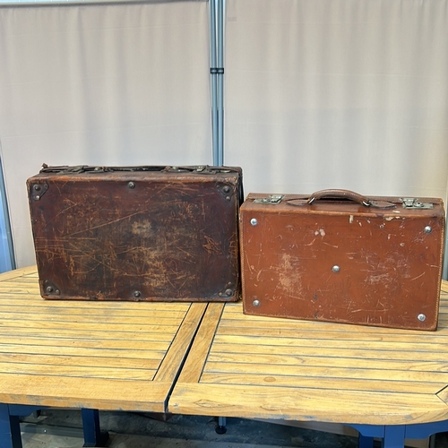 58 - Vintage leather suitcases with sturdy handles, brass clasps, and original interior linings. Features... 