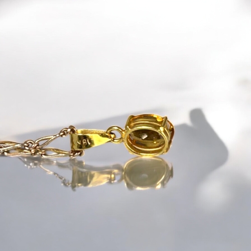 551 - An 18ct gold & Citrine ladies pendant. On a 9ct gold Figaro link chain.