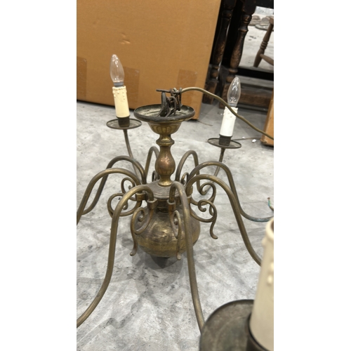 191 - Vintage brass chandelier with eight arms, featuring a classic scroll design and candle-style bulb ho... 