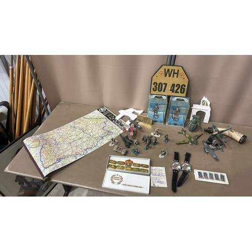 194 - Mixed lot featuring World War II memorabilia, map, toy soldiers, aircraft models, and military-theme... 