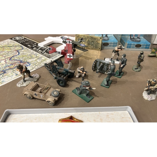 194 - Mixed lot featuring World War II memorabilia, map, toy soldiers, aircraft models, and military-theme... 