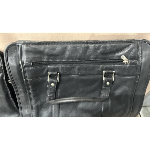 196 - Black leather Dents bag with wing-shaped logo. Established 1777, known for high-quality leather good... 