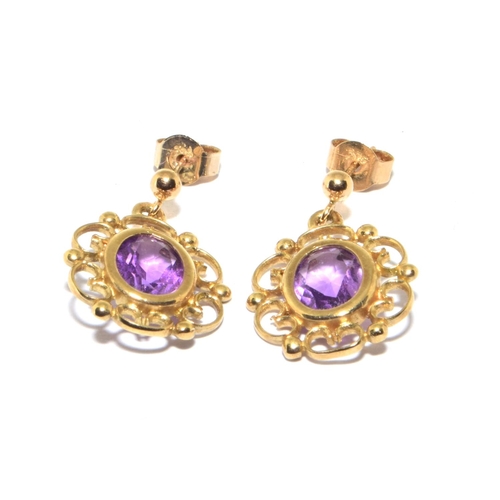 123 - 9ct gold Amethyst stud earrings in an openwork scroll setting