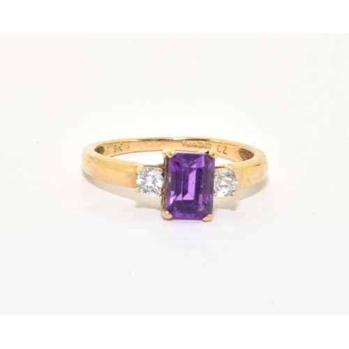 141 - 9ct gold ladies good emerald cut Amethyst solitaire with clear stone decoration size P