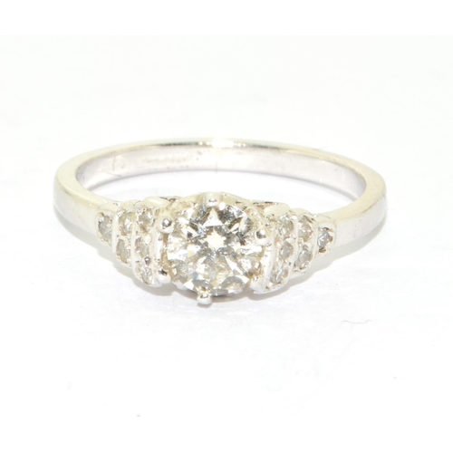 156 - 18ct white gold Diamond set ring the central stone flanked by graduated diamond shoulders size M