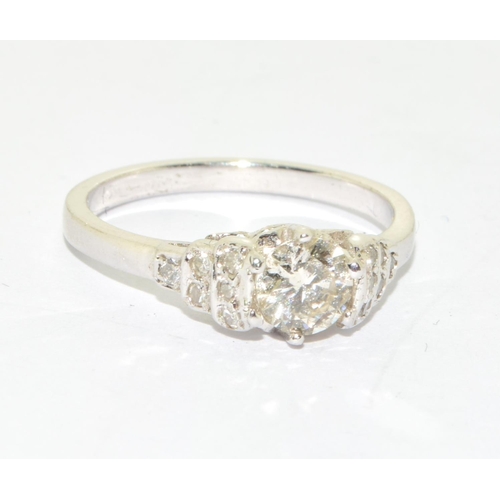 156 - 18ct white gold Diamond set ring the central stone flanked by graduated diamond shoulders size M