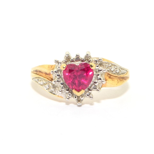 158 - 9ct gold ladies diamond heart design ring with a red Rubellite love heart centre stone size O