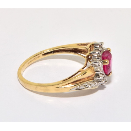 158 - 9ct gold ladies diamond heart design ring with a red Rubellite love heart centre stone size O