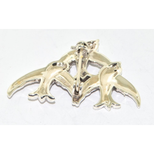 278 - silver and marcasite brooch in the form of three birds with ruby eyes