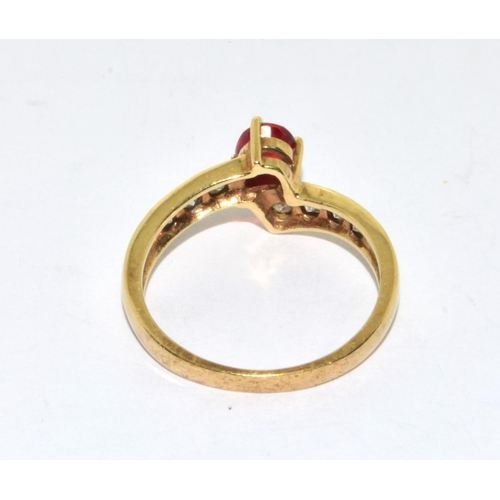 296 - 9ct gold ladies vintage Diamond and Ruby cross over ring size N