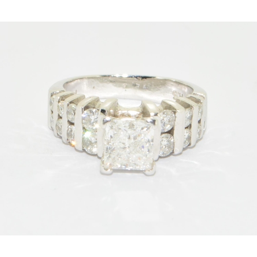 328 - A good 14ct white gold Emerald cut Diamond central stone ring with Brilliant cut Diamond shoulders s... 