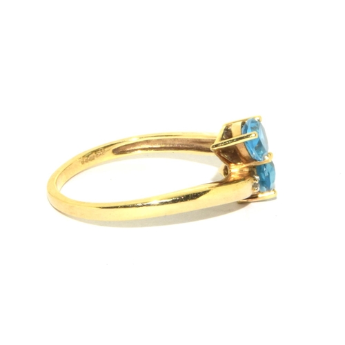 336 - 9ct gold ladies Aquamarine and accent Diamond shoulder twist design ring size T