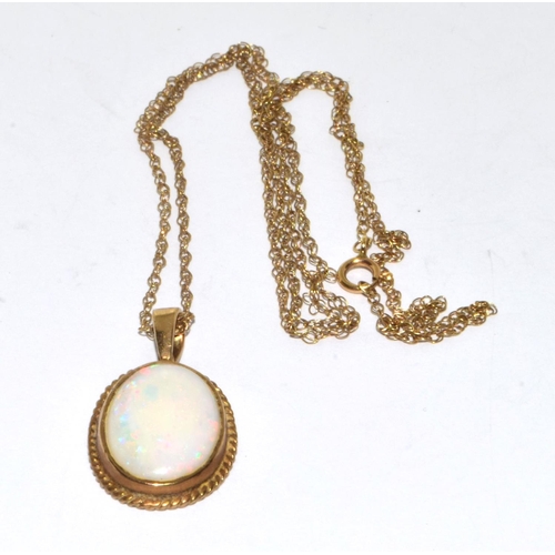 358 - 9ct gold large Opal oval pendant necklace set in a scroll setting on a 46cm gold chain